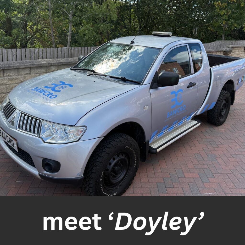 Meet Doyley – One of the Bawcro Gritters on Winter Duty. - Bawcro Snow & Gritting Services Ltd Silver Mitsubishi Pick-up Truck with Bawcro Branding Parked on a Brick Driveway.