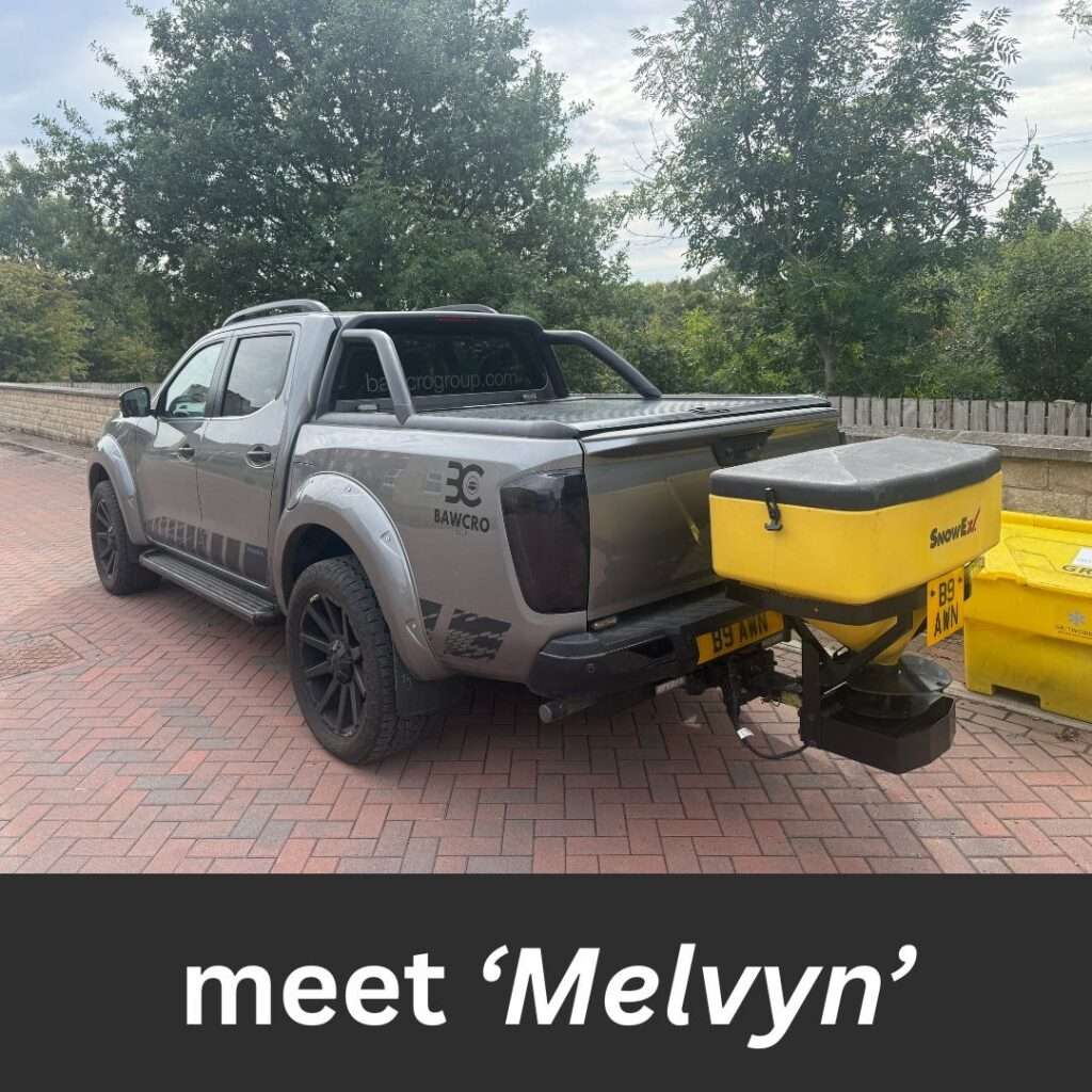 Meet Melvyn – Spreading Salt and Smiles Across Yorkshire. - Bawcro Snow & Gritting Services Ltd Grey Nissan Pick-up Truck with Yellow Rear Salt Spreader Parked Beside Grit Bins.