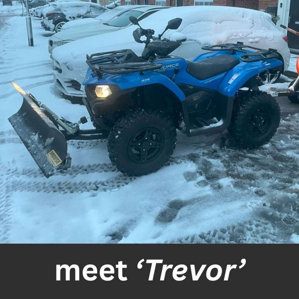 Meet Trevor – the Quad That Gets Where Others Can’t. - Bawcro Snow & Gritting Services Ltd Blue Quad Bike with Snow Plough Attachment Ready for Gritting a Car Park.